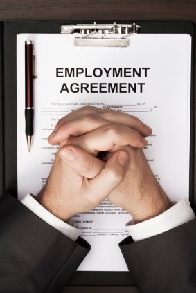 Man With Clasped Hands Over Employment Agreement Document